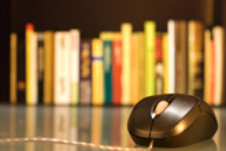 Computer mouse in front of bookshelf