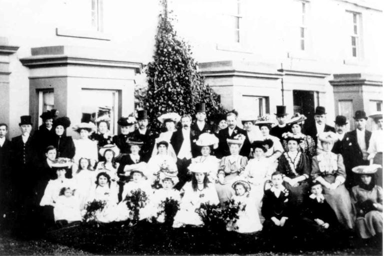 Wedding party outside a property in Seascale